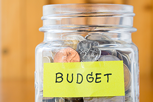 photo of a clear glass jar containing coins and labeled 