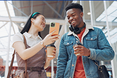 Gen-Z-Shop photo of 2 young Gen Z age people looking at a smartphone screen