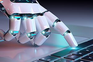 image of a robotic hand on a computer keyboard