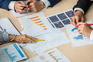 photo of executives in a group looking at graphical data